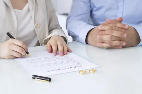 couple signing divorce papers in law office
