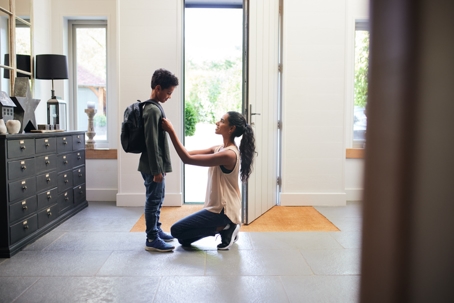 mother seeing off son as he leaves home