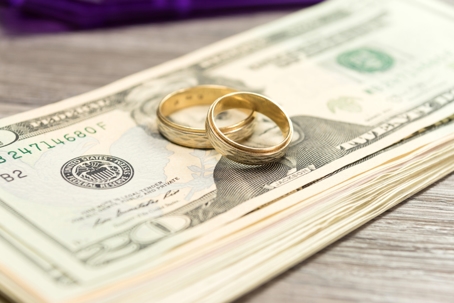 wedding rings on top of cash